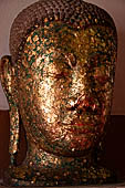Ayutthaya, Thailand. Viharn Phra Mongkhon Bophit, Buddha heads covered in gold leaves. 